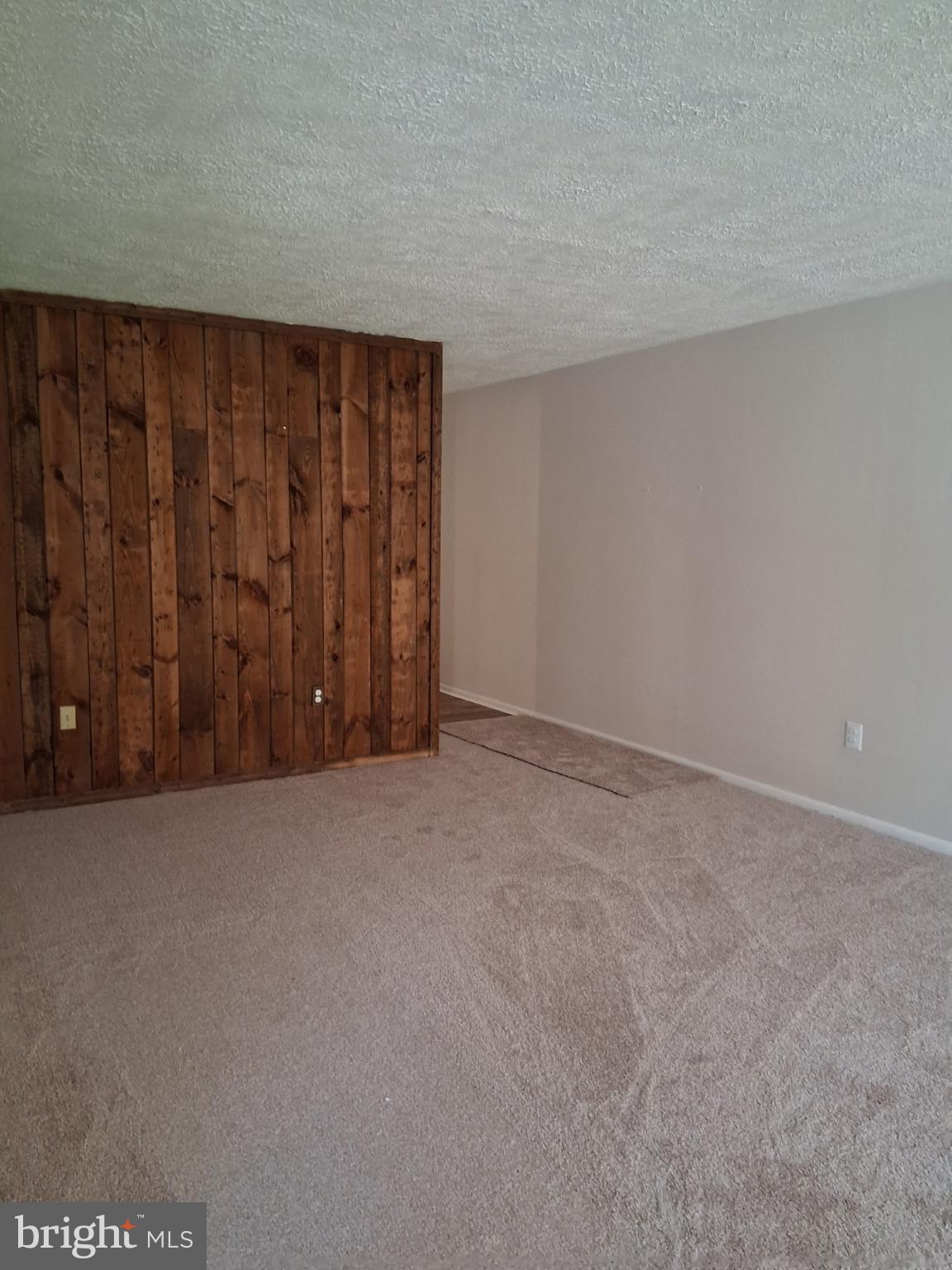 8479 Greenbelt Road, Unit 102 Greenbelt, MD 20770 - Photo 13 of 14 a view of an empty room and wooden door