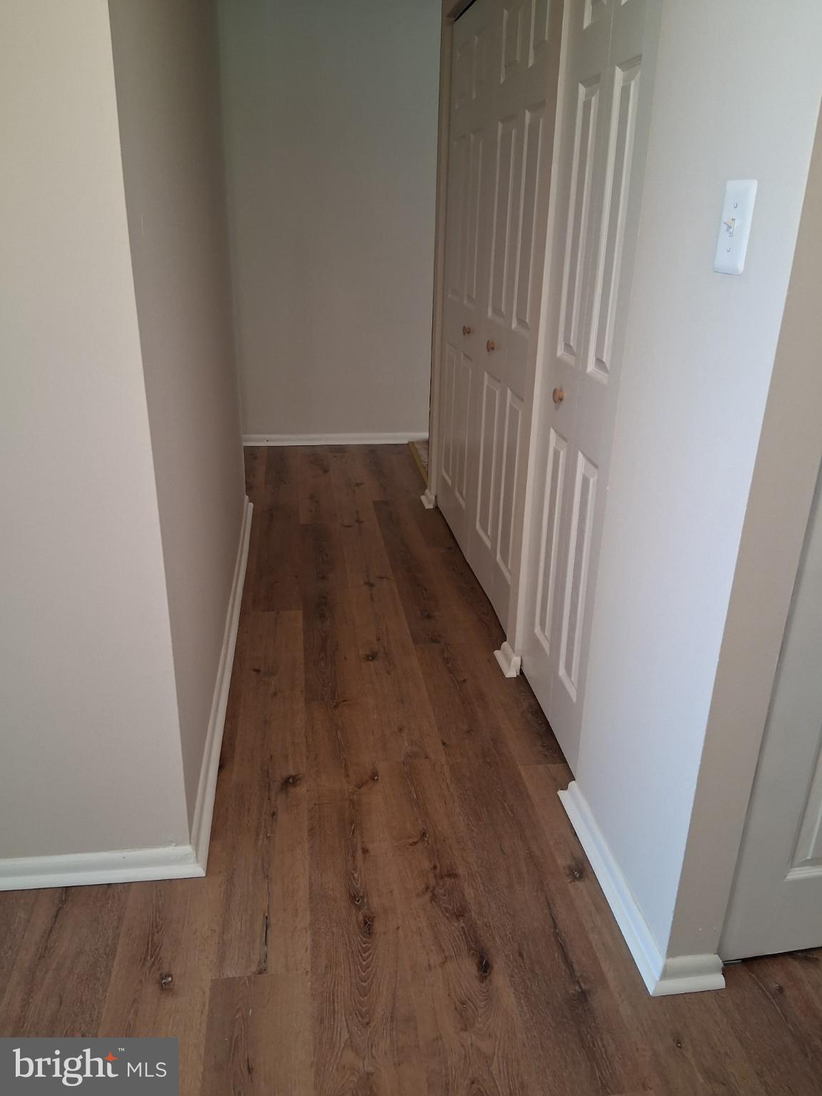 8479 Greenbelt Road, Unit 102 Greenbelt, MD 20770 - Photo 14 of 14 a view of a hallway with wooden floor