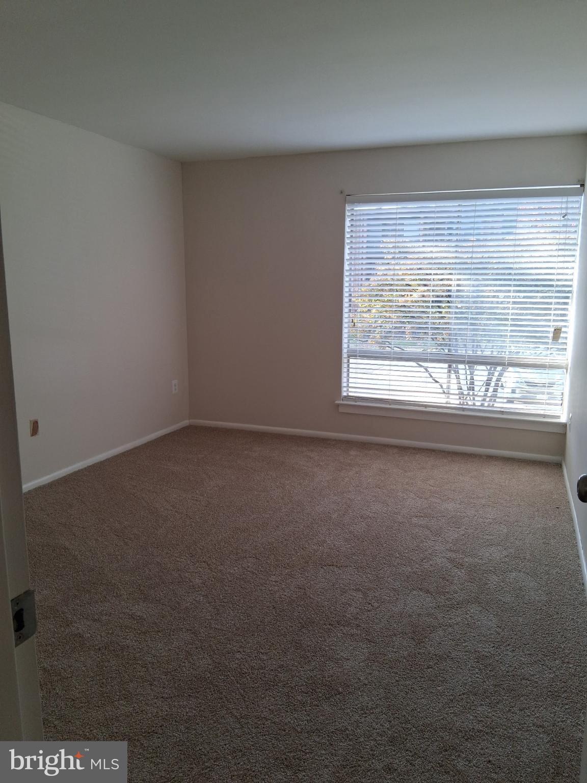 8479 Greenbelt Road, Unit 102 Greenbelt, MD 20770 - Photo 5 of 14 an empty room with a window