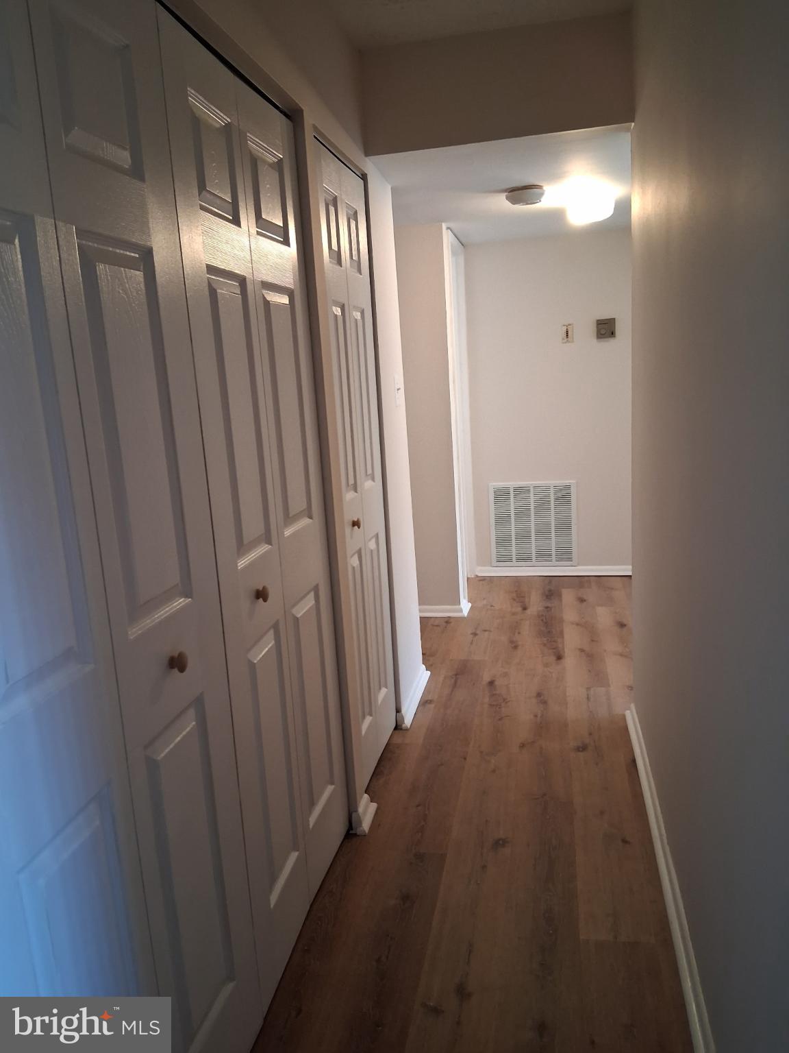 8479 Greenbelt Road, Unit 102 Greenbelt, MD 20770 - Photo 9 of 14 a view of a room with wooden floor and windows