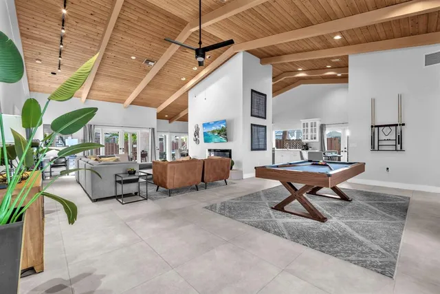 a living room with furniture a rug and a chandelier