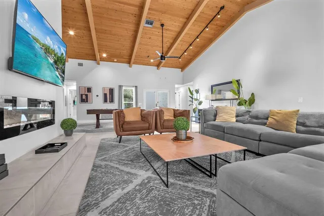 a living room with furniture and a chandelier