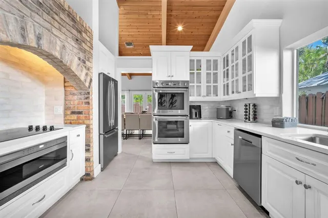 a kitchen with stainless steel appliances granite countertop a stove and a refrigerator