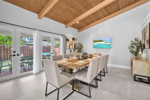 a view of a dining room with furniture window and outside view