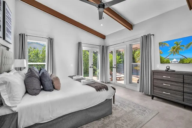 a bedroom with a bed and a flat screen tv