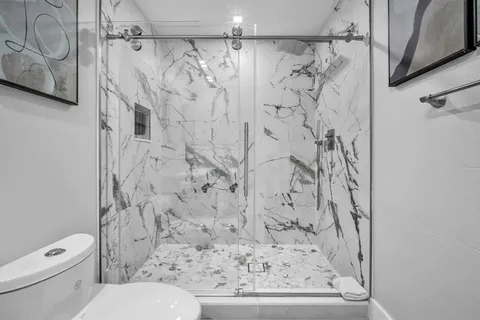 a bathroom with a toilet and shower curtain