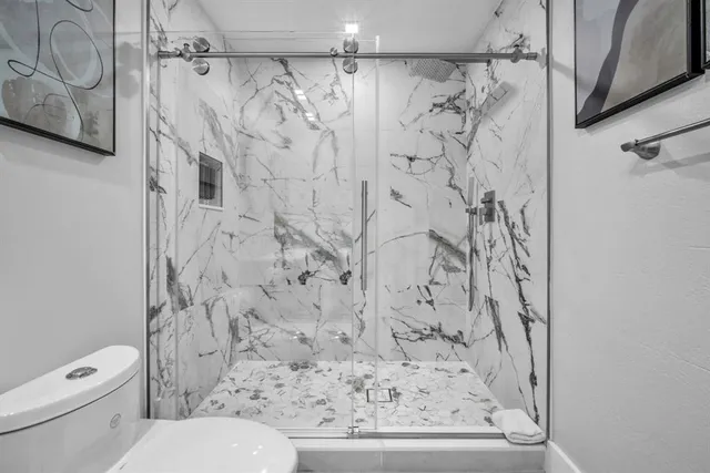 a bathroom with a toilet and shower curtain