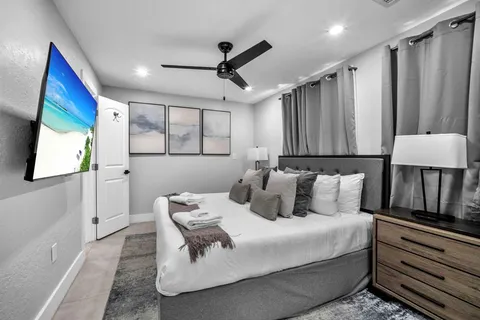 a bedroom with a large bed and a mirror