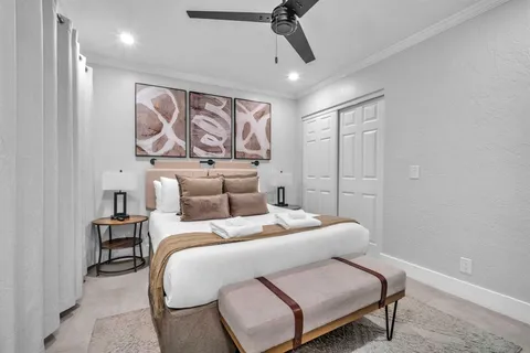 a bedroom with a bed a mirror and furniture