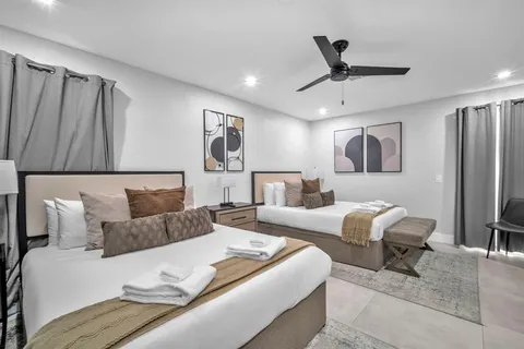 a bed room with a bed furniture and a large window