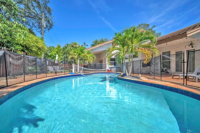 a backyard of a house with table and chairs