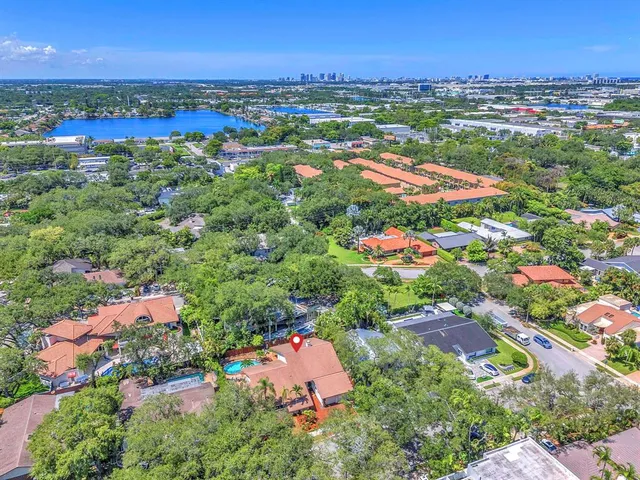 an aerial view of residential houses with outdoor space and street view