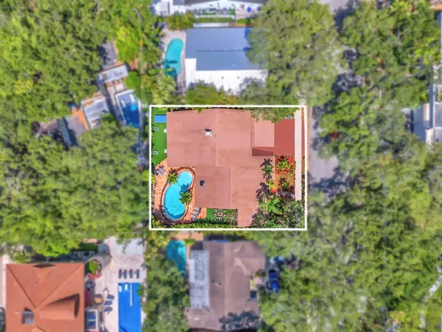 an aerial view of a house with a yard