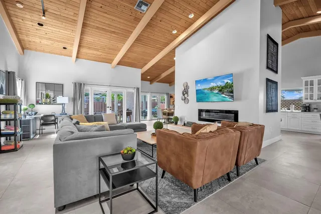 a living room with fireplace furniture and a flat screen tv