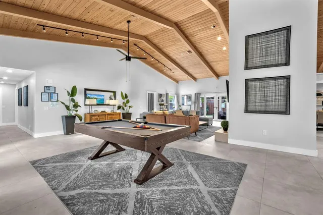 a living room with furniture a rug and a table