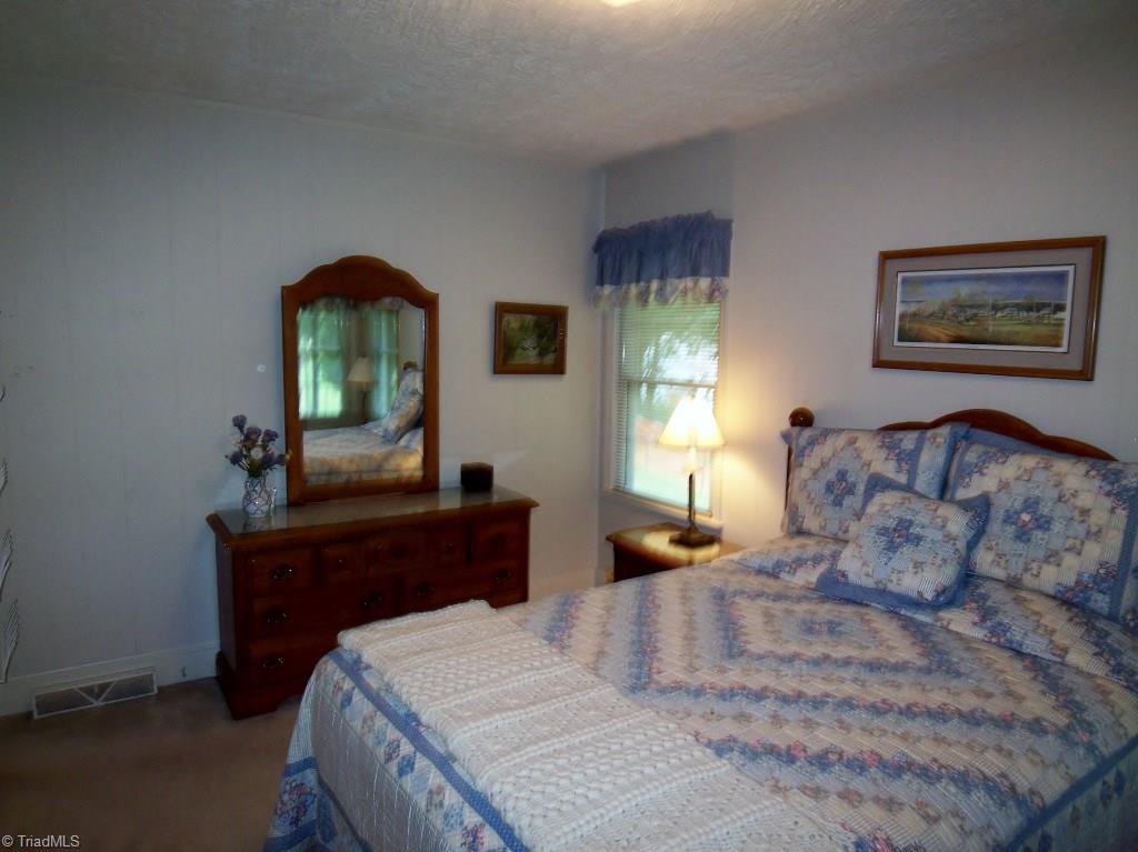 3158 Dillon Road Jamestown, NC 27282 - Photo 17 of 26 Bedroom 2 with Hardwood Floor under the Carport