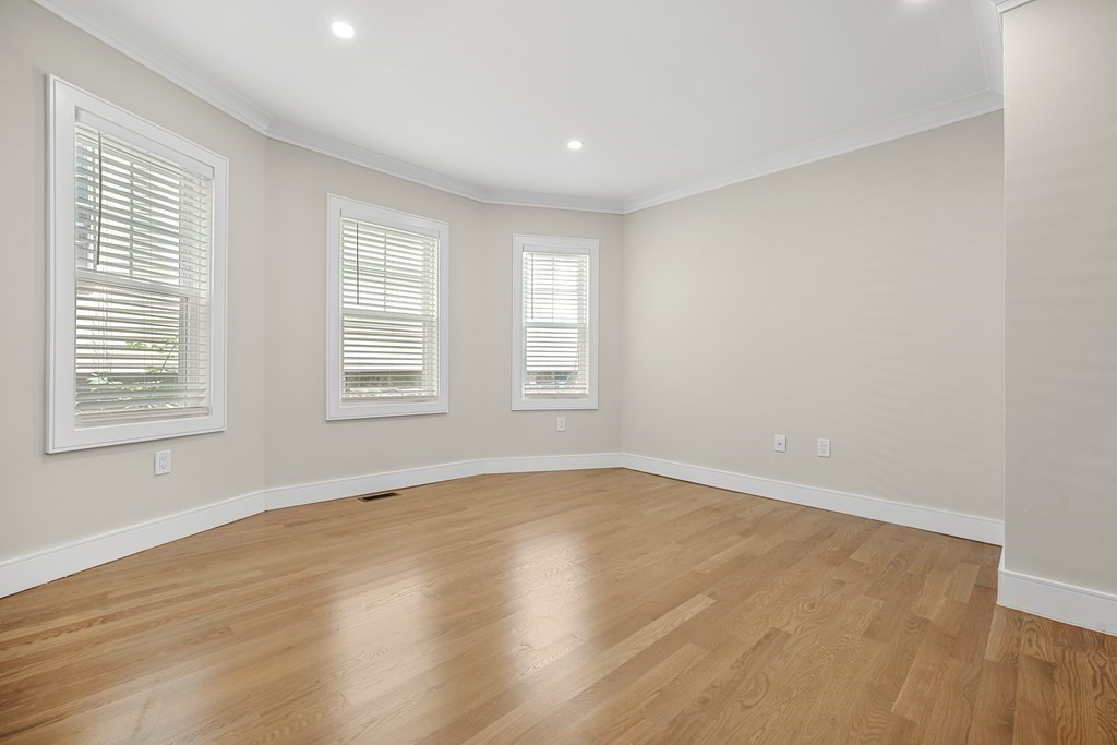 44 Iffley Road Boston, MA 02130 - Photo 12 of 19 a view of an empty room with wooden floor and a window