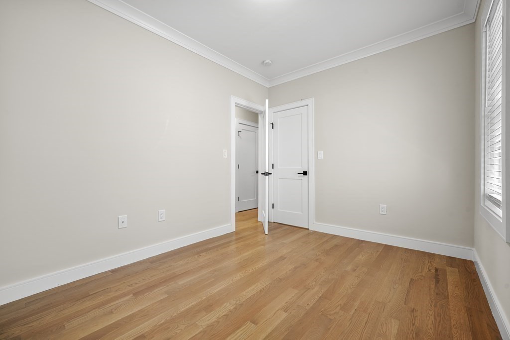 44 Iffley Road Boston, MA 02130 - Photo 13 of 19 a view of an empty room with wooden floor