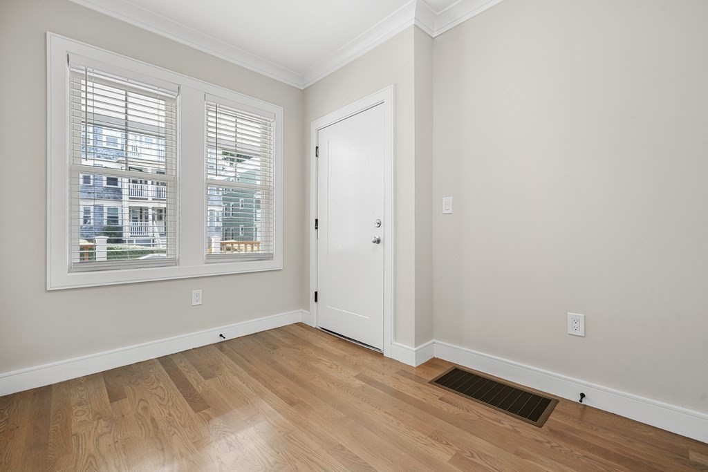 44 Iffley Road Boston, MA 02130 - Photo 14 of 19 an empty room with wooden floor and windows