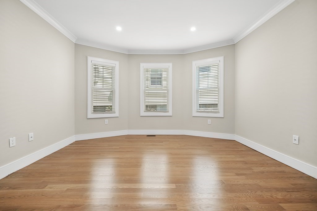 44 Iffley Road Boston, MA 02130 - Photo 7 of 19 an empty room with wooden floor and windows