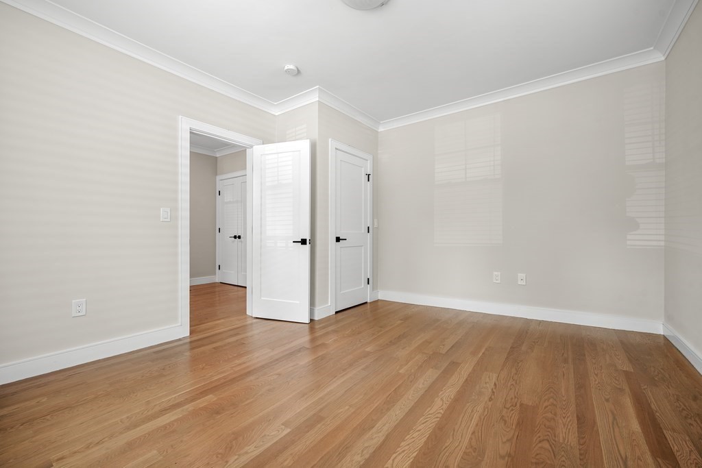 44 Iffley Road Boston, MA 02130 - Photo 8 of 19 a view of an empty room with wooden floor