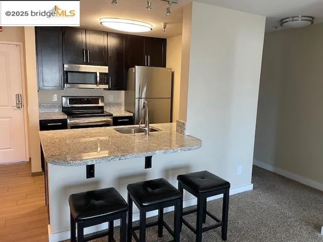 a kitchen with cabinets and stainless steel appliances