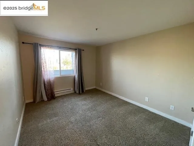 a view of an empty room and a window