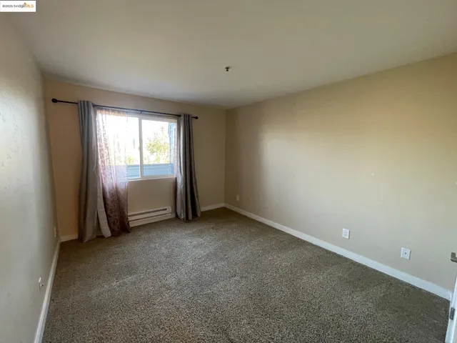 a view of an empty room and a window