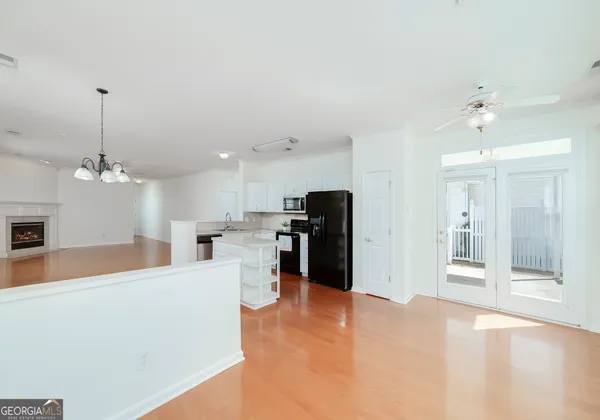 a view of a kitchen with a sink and refrigerator