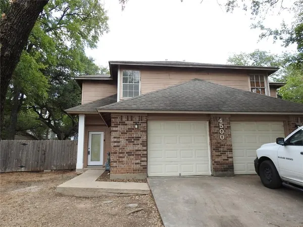 a front view of a house with garage