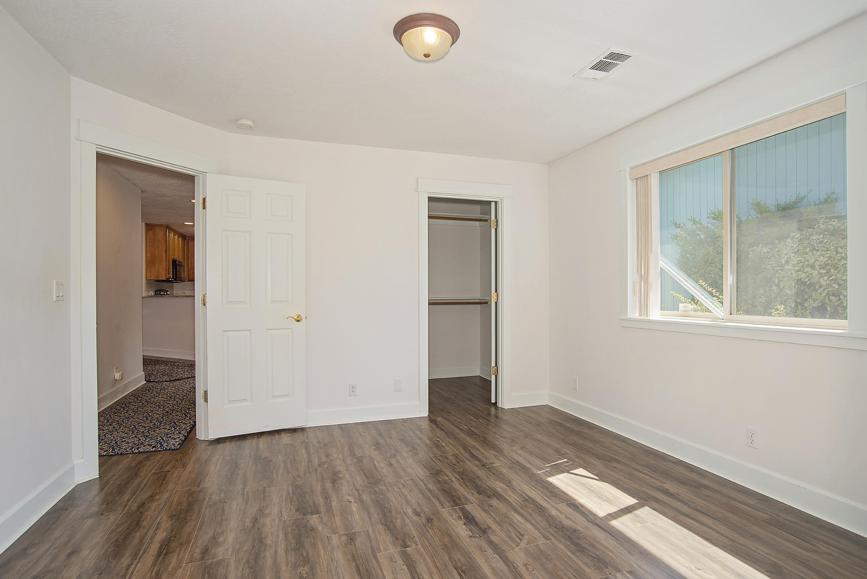 992 Spring Way Ashland, OR 97520 - Photo 17 of 21 an empty room with wooden floor and windows