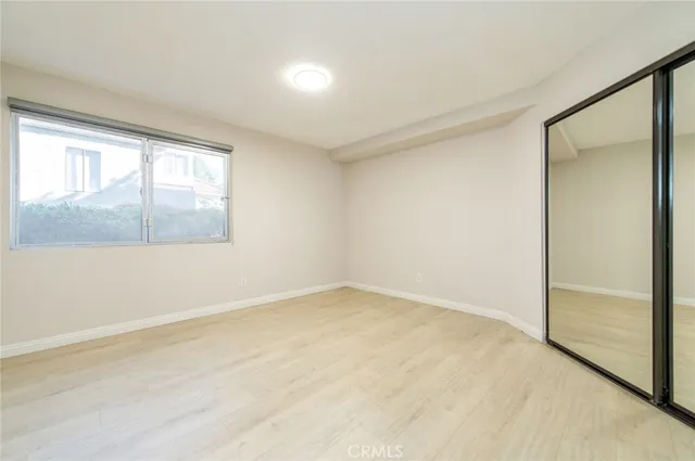 a spacious bedroom with a large bed and a flat screen tv