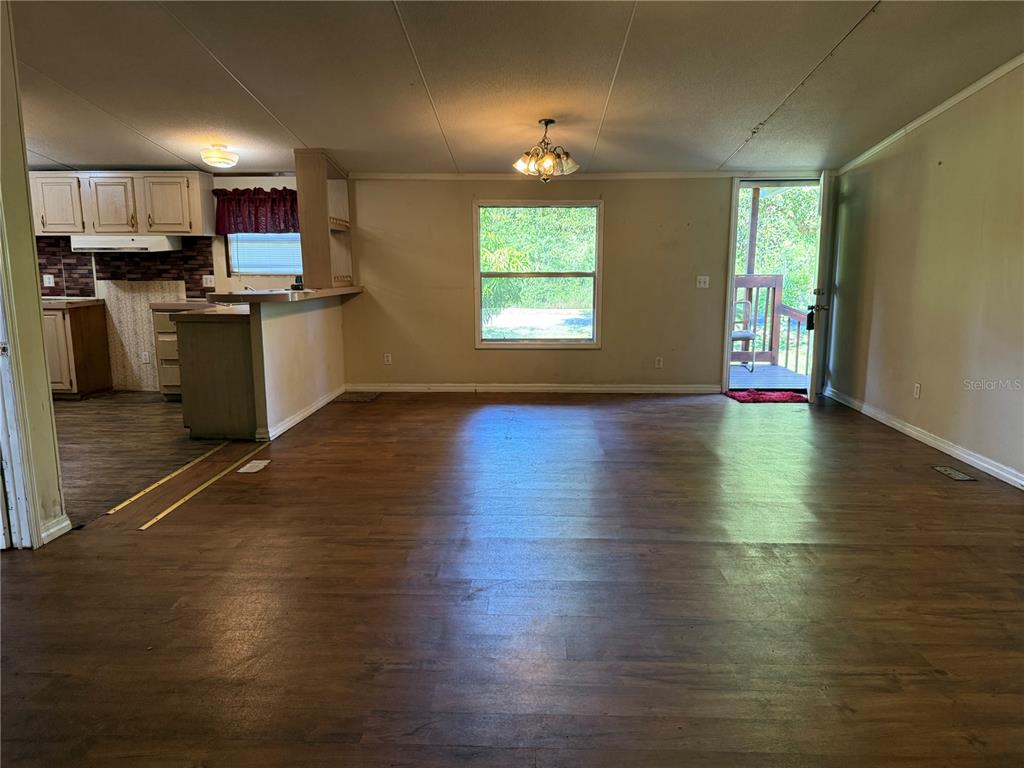 1107 Carmichael Place Dover, FL 33527 - Photo 3 of 17 a kitchen with stainless steel appliances granite countertop a stove and a wooden floors