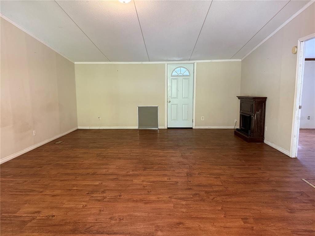 1107 Carmichael Place Dover, FL 33527 - Photo 4 of 17 a view of an empty room with wooden floor