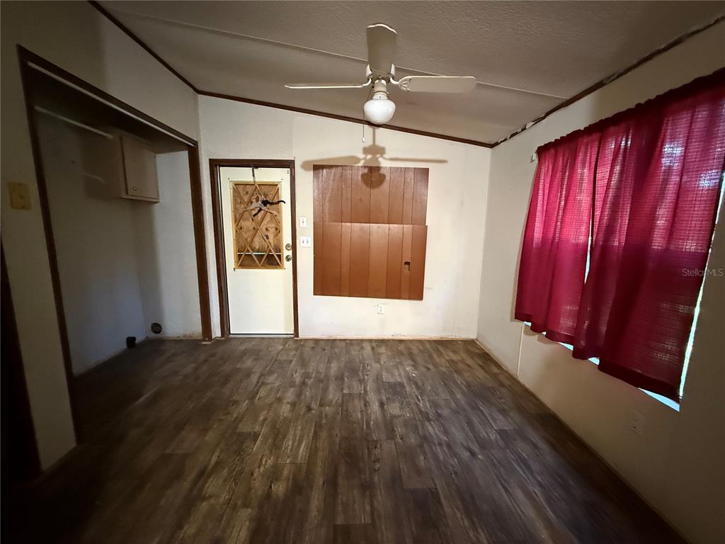 1107 Carmichael Place Dover, FL 33527 - Photo 7 of 17 a view of a room with wooden floor and windows