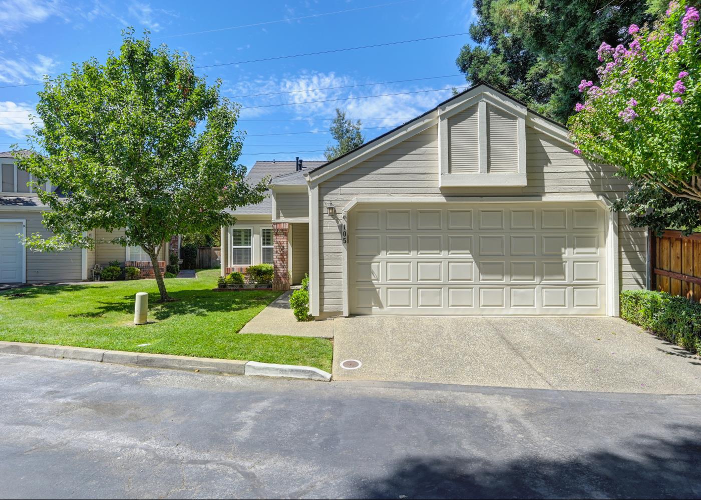 a front view of house with yard and green space