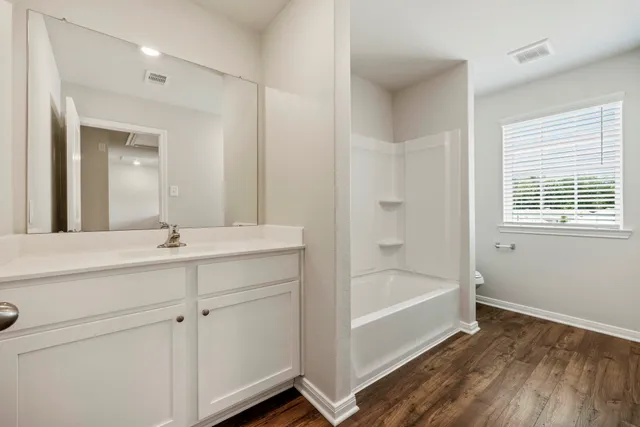 a bathroom with a glass shower door
