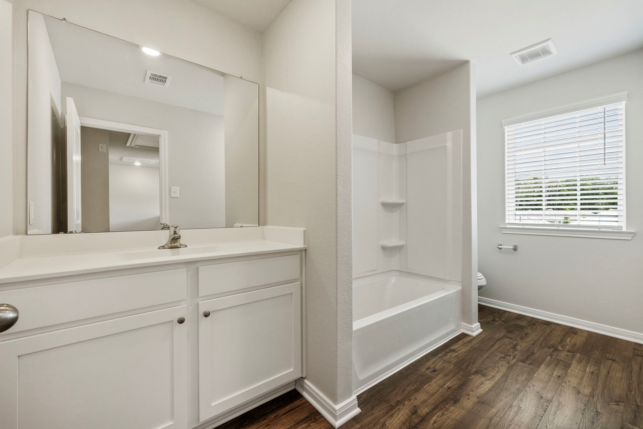 10414 Red Cardinal Drive Cleveland, TX 77328 - Photo 8 of 12 a bathroom with a tub sink and mirror