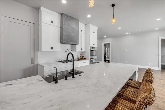 an empty room with wooden floor & windows