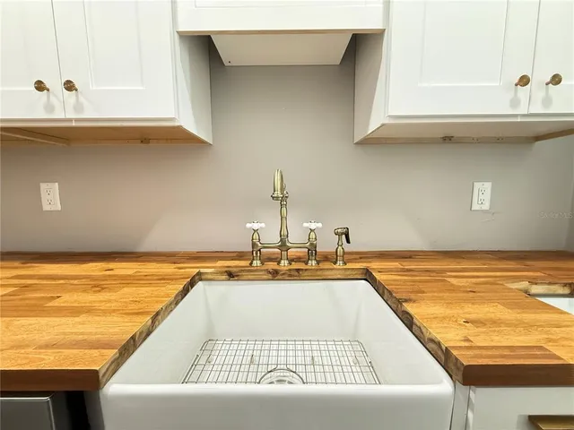 an empty room with wooden floor and a bathroom