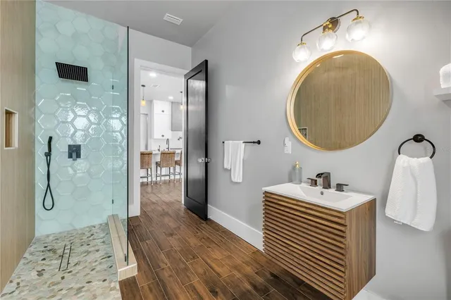 a view of empty room with wooden floor