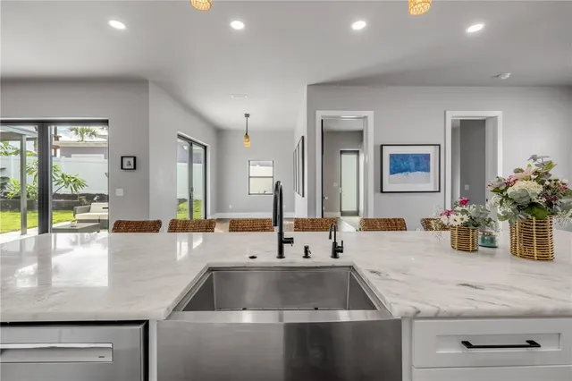 a view of an outdoor dining space with a table and chairs