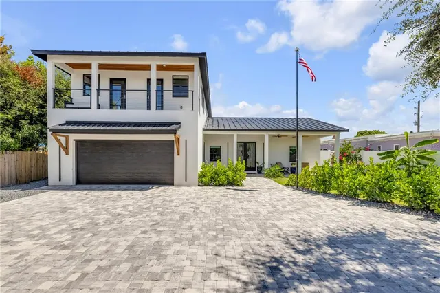 a large kitchen with kitchen island a stove a sink a refrigerator and a dining table view