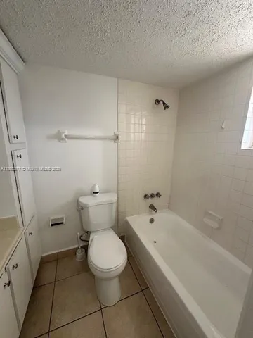 a bathroom with a toilet and shower