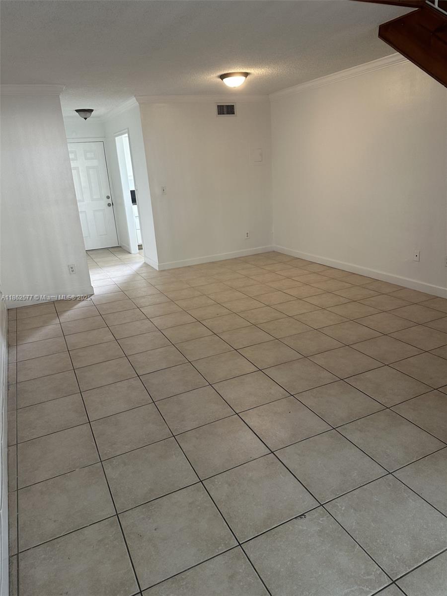 8600 Southwest 109th Avenue, Unit 4216 Miami, FL 33173 - Photo 8 of 20 an empty room with a fireplace and cabinet