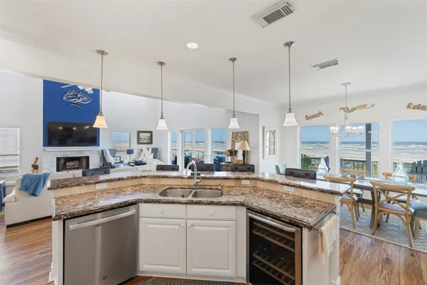 a large kitchen with stainless steel appliances kitchen island granite countertop a stove and a refrigerator