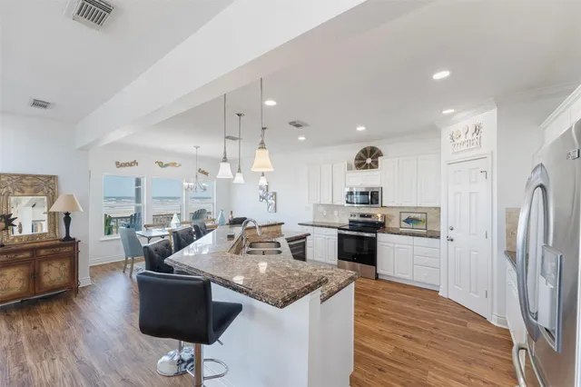 a living room with kitchen island furniture and a wooden floor
