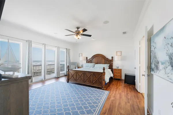a bedroom with a large bed and a large window