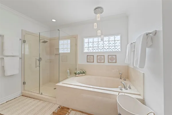 a spacious bathroom with a double vanity sink a large mirror and shower