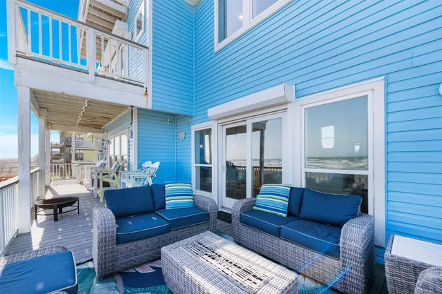 a view of a balcony with chairs and a table